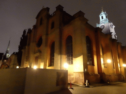 Northeast side of the Saint Nicolaus Church at the Storkyrkobrinken street and the tower of the German Church, by night