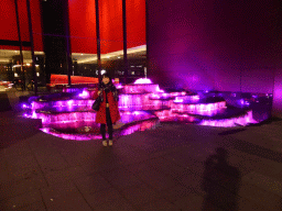 Miaomiao in front of a fountain at Bathurst Street, by night
