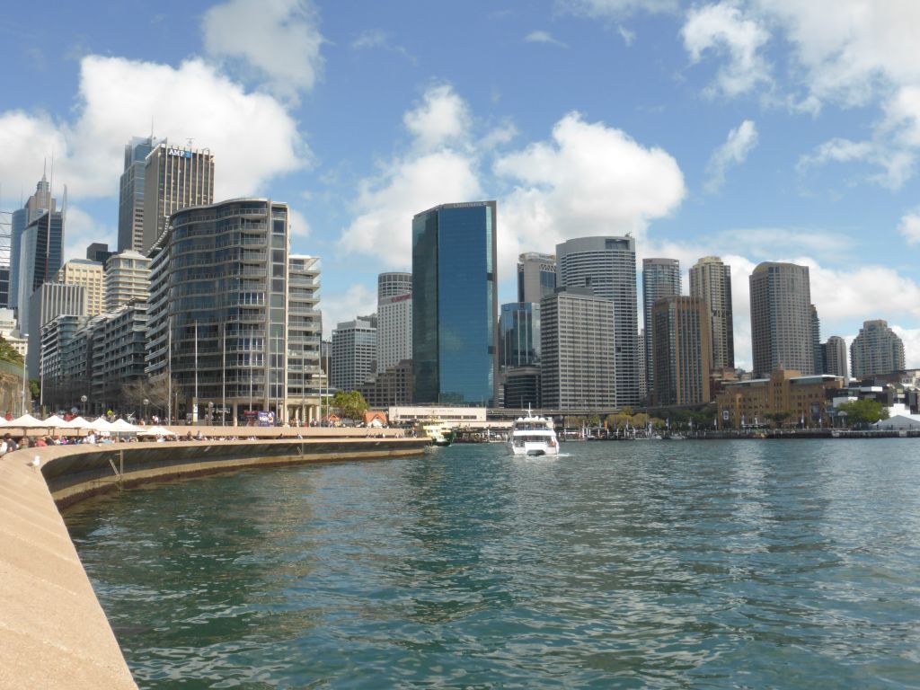 The Sydney Cove, the Circular Quay Wharf, the Circular Quay Railway Station and skyscrapers at the city center, viewed from the Lower Concourse of the Sydney Opera House
