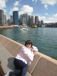 Miaomiao at the Lower Concourse of the Sydney Opera House, with a view on the Sydney Cove, the Circular Quay Wharf, the Circular Quay Railway Station and skyscrapers at the city center