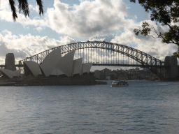 The Sydney Harbour, the Sydney Opera House and the Sydney Harbour Bridge, viewed from Mrs Macquarie`s Road at the Royal Botanic Gardens