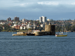 Boat in the Sydney Harbour, Fort Denison and the Mattawunga neighbourhood, viewed from Mrs Macquarie`s Point at the Royal Botanic Gardens