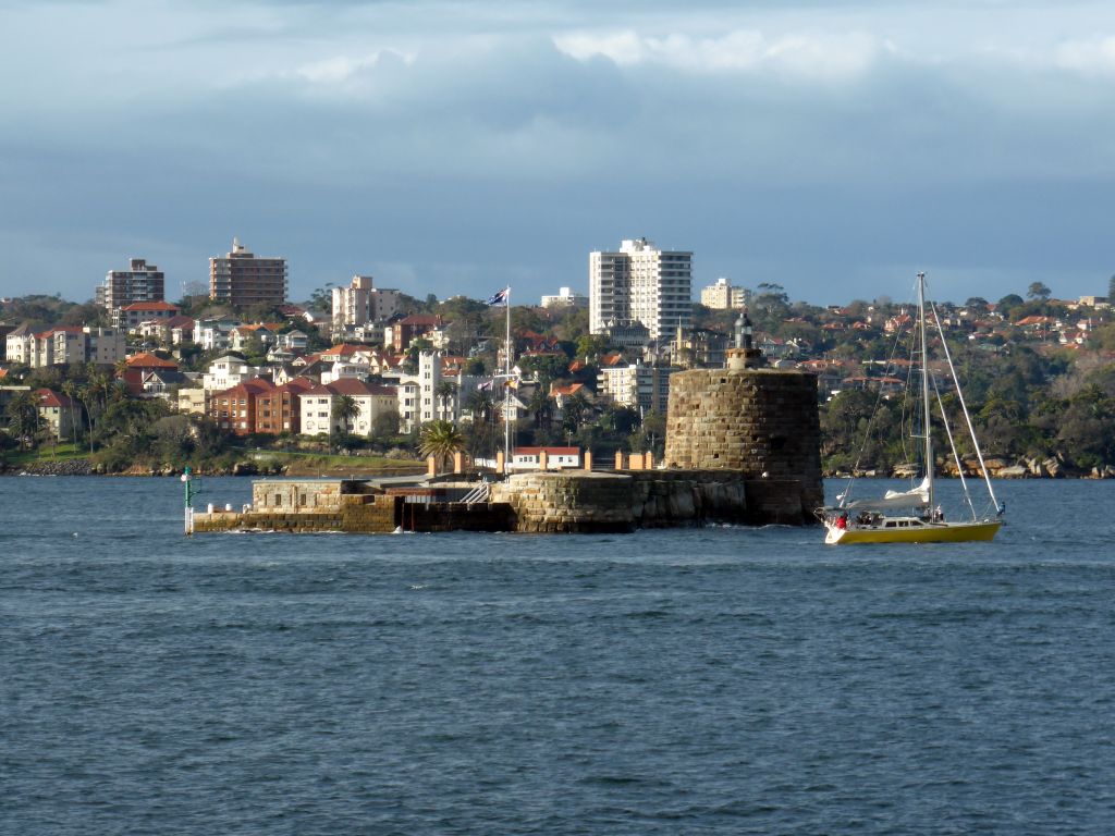 Boat in the Sydney Harbour, Fort Denison and the Mattawunga neighbourhood, viewed from Mrs Macquarie`s Point at the Royal Botanic Gardens