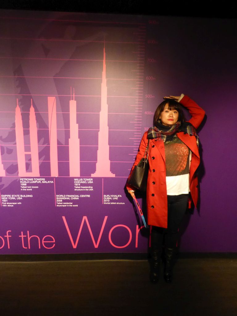 Miaomiao at a poster with famous towers at the Sydney Tower Eye exhibition at the Sydney Tower