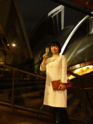 Miaomiao with a glass of wine at the Northern Foyer of the Joan Sutherland Theatre at the Sydney Opera House, with a view on the northwest side of the Sydney Opera House, by night
