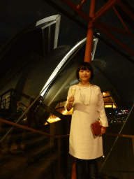 Miaomiao with a glass of wine at the Northern Foyer of the Joan Sutherland Theatre at the Sydney Opera House, with a view on the northwest side of the Sydney Opera House, by night