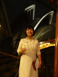 Miaomiao with a glass of wine at the Northern Foyer of the Joan Sutherland Theatre at the Sydney Opera House, with a view on the northwest side of the Sydney Opera House, by night