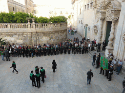 People preparing for the procession during the feast of St. Lucy in front of the Chiesa di Santa Lucia alla Badia church at the Piazza Duomo Square, viewed from the balcony of the Palazzo Borgia del Casale palace