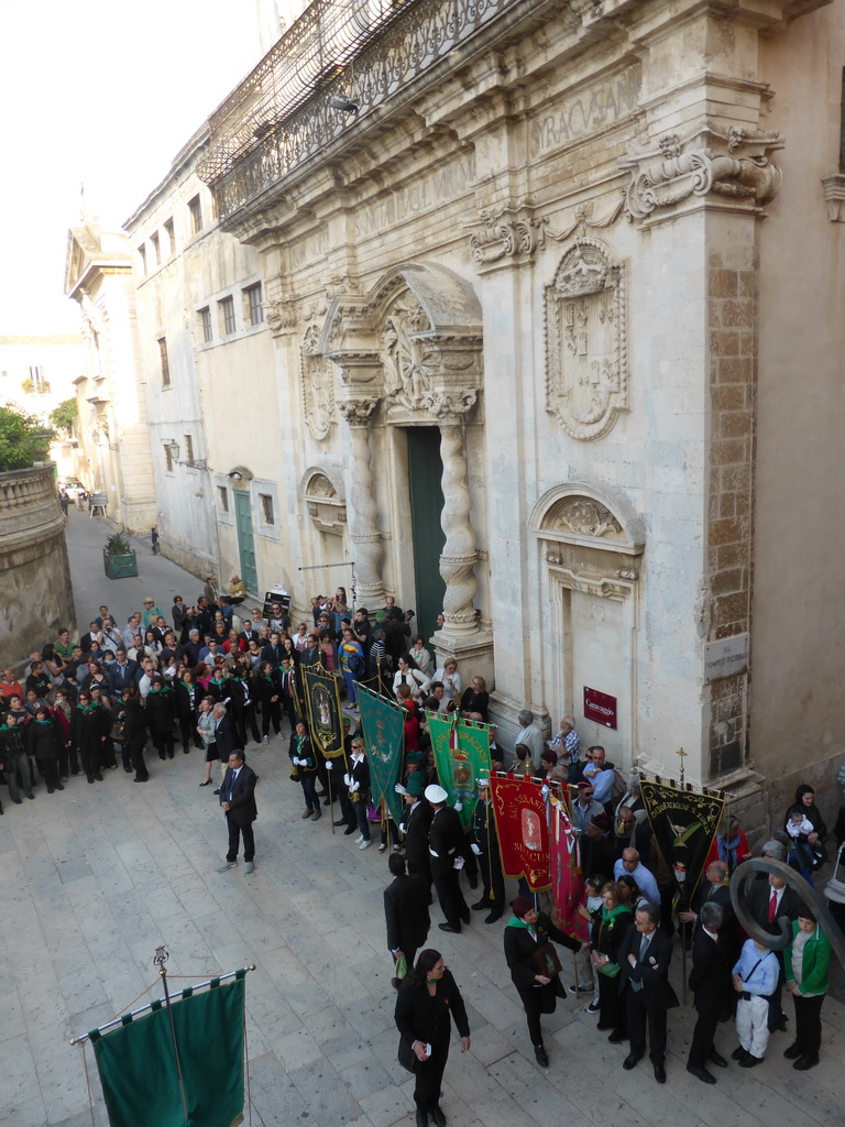 People preparing for the procession during the feast of St. Lucy in front of the Chiesa di Santa Lucia alla Badia church at the Piazza Duomo Square, viewed from the balcony of the Palazzo Borgia del Casale palace