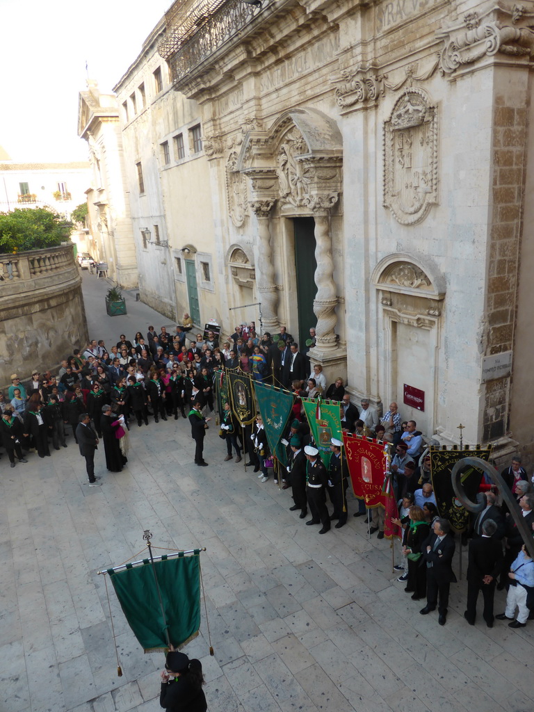 People preparing for the procession during the feast of St. Lucy in front of the Chiesa di Santa Lucia alla Badia church at the Piazza Duomo Square, viewed from the balcony of the Palazzo Borgia del Casale palace