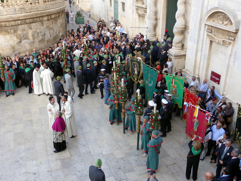 People preparing for the procession during the feast of St. Lucy in front of the Chiesa di Santa Lucia alla Badia church at the Piazza Duomo Square, viewed from the balcony of the Palazzo Borgia del Casale palace