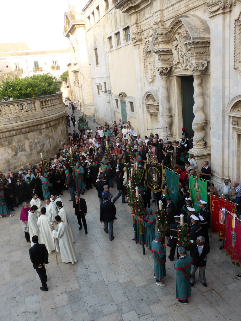 People preparing for the procession during the feast of St. Lucy in front of the Chiesa di Santa Lucia alla Badia church at the Piazza Duomo Square, viewed from the balcony of the Palazzo Borgia del Casale palace