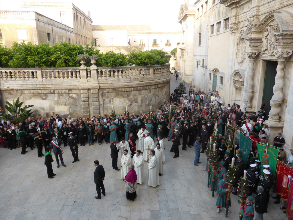 People preparing for the procession during the feast of St. Lucy in front of the Chiesa di Santa Lucia alla Badia church at the Piazza Duomo Square, viewed from the balcony of the Palazzo Borgia del Casale palace