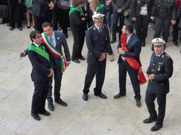 Officials preparing for the procession during the feast of St. Lucy at the Piazza Duomo Square, viewed from the balcony of the Palazzo Borgia del Casale palace