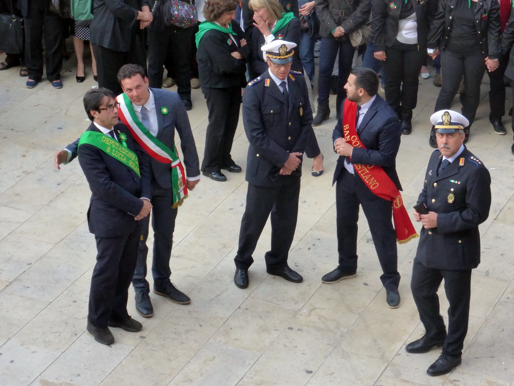 Officials preparing for the procession during the feast of St. Lucy at the Piazza Duomo Square, viewed from the balcony of the Palazzo Borgia del Casale palace