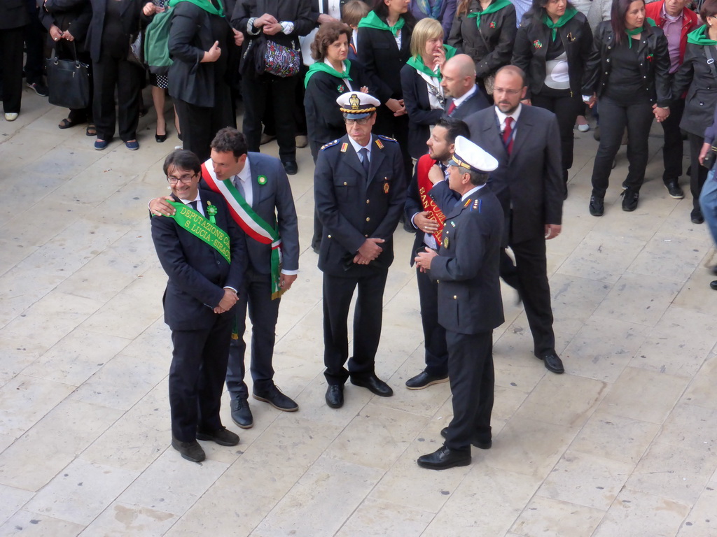 Officials preparing for the procession during the feast of St. Lucy at the Piazza Duomo Square, viewed from the balcony of the Palazzo Borgia del Casale palace