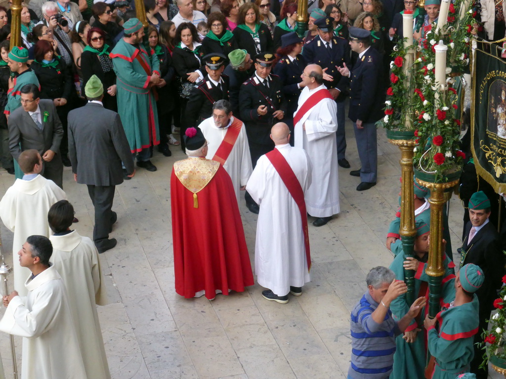 Priests preparing for the procession during the feast of St. Lucy at the Piazza Duomo Square, viewed from the balcony of the Palazzo Borgia del Casale palace