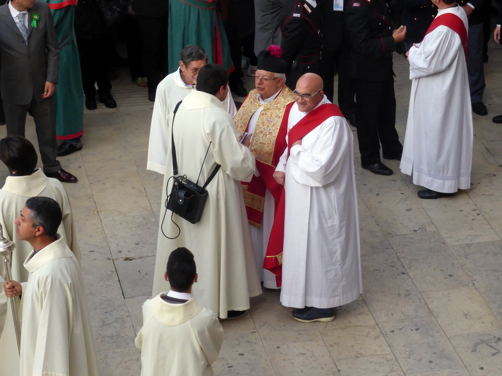 Priests preparing for the procession during the feast of St. Lucy at the Piazza Duomo Square, viewed from the balcony of the Palazzo Borgia del Casale palace