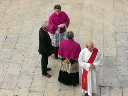 Priests preparing for the procession during the feast of St. Lucy at the Piazza Duomo Square, viewed from the balcony of the Palazzo Borgia del Casale palace