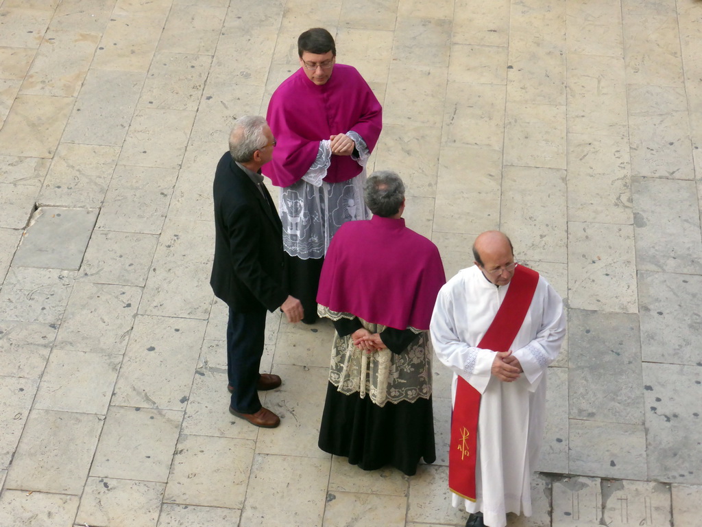 Priests preparing for the procession during the feast of St. Lucy at the Piazza Duomo Square, viewed from the balcony of the Palazzo Borgia del Casale palace