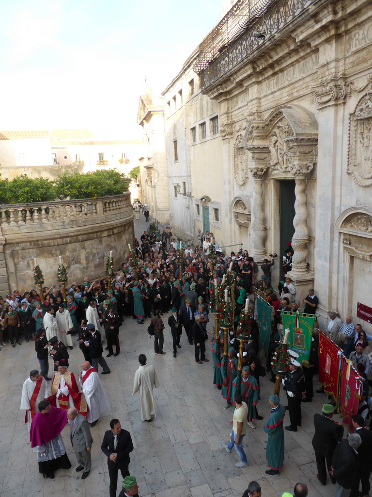 People preparing for the procession during the feast of St. Lucy in front of the Chiesa di Santa Lucia alla Badia church at the Piazza Duomo Square, viewed from the balcony of the Palazzo Borgia del Casale palace