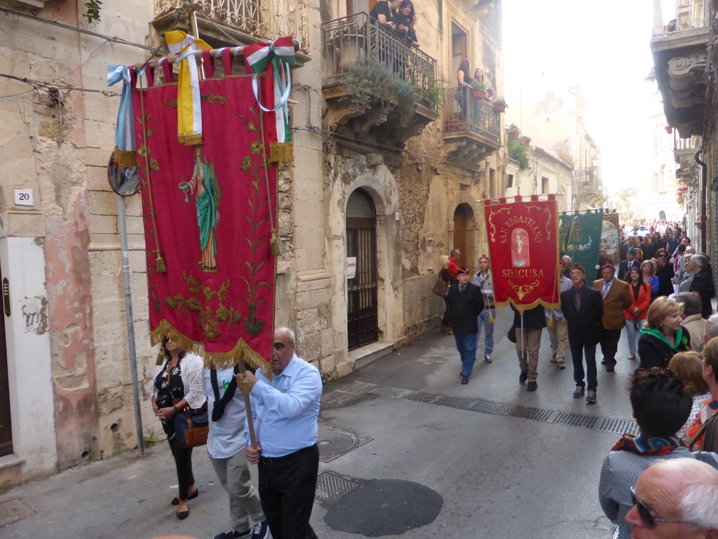 People carrying banners at the procession during the feast of St. Lucy at the Via Castello Maniace street