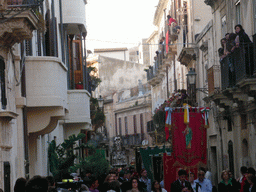 People carrying banners and the statue of St. Lucy at the procession during the feast of St. Lucy at the Via Castello Maniace street, viewed from the Lungomare Alfeo street