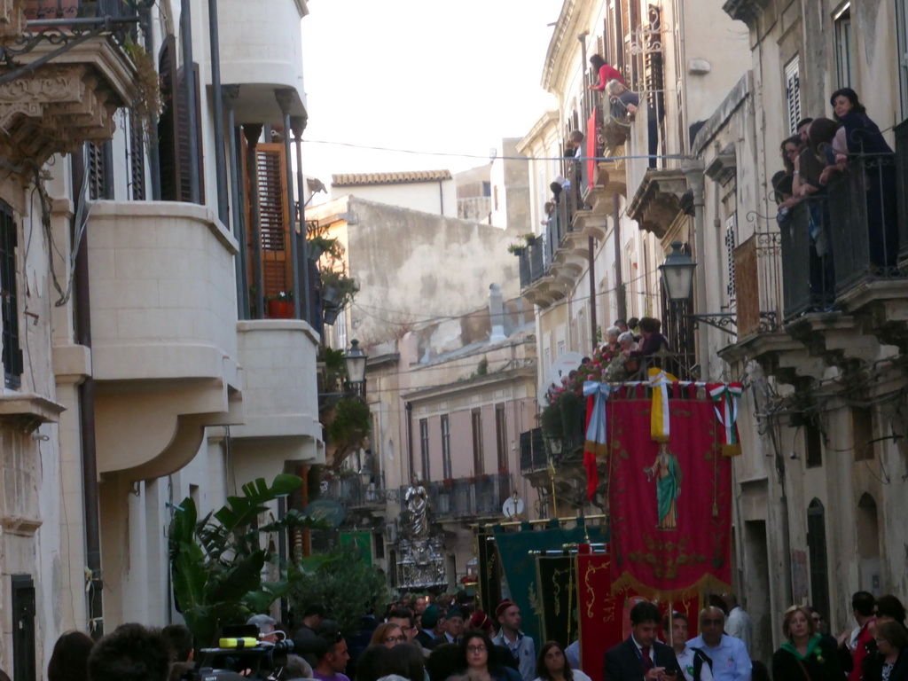 People carrying banners and the statue of St. Lucy at the procession during the feast of St. Lucy at the Via Castello Maniace street, viewed from the Lungomare Alfeo street