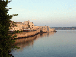 Southwest coastline of Ortygia with the Castello Maniace castle, viewed from the viewpoint near the Fonte Aretusa fountain, at sunset