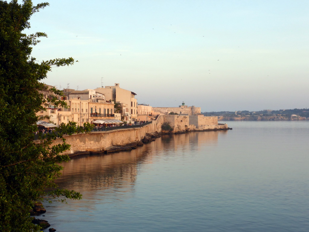 Southwest coastline of Ortygia with the Castello Maniace castle, viewed from the viewpoint near the Fonte Aretusa fountain, at sunset