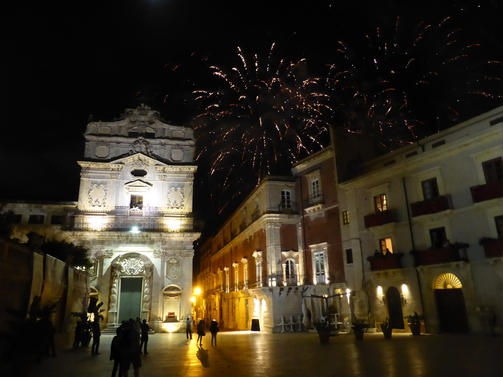 Fireworks during the feast of St. Lucy at the Chiesa di Santa Lucia alla Badia church and the Palazzo Borgia del Casale palace at the Piazza Duomo Square, by night