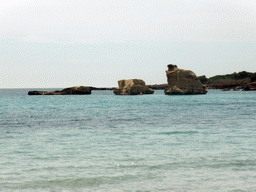 Rocks in the water at the Lido Sayonara beach at the village of Fontane Bianche