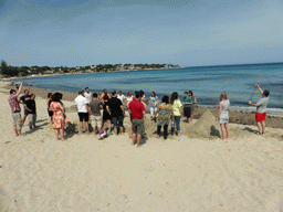 Course participants with the letters in the sand at the Lido Sayonara beach at the village of Fontane Bianche