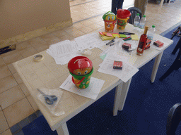 Course material and a bottle of wine on the table at the building used for the team building exercise at the Lido Sayonara beach at the village of Fontane Bianche