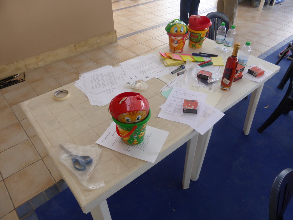 Course material and a bottle of wine on the table at the building used for the team building exercise at the Lido Sayonara beach at the village of Fontane Bianche