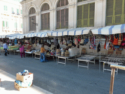 Market stalls with cloth and purses at the Via del Mercato street