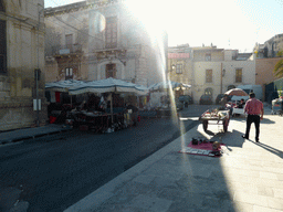 Market stalls with cloth and purses at the Via del Mercato street