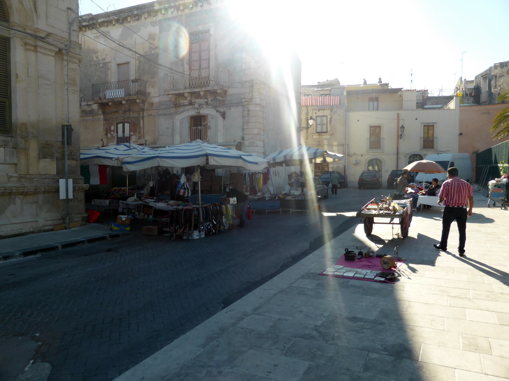 Market stalls with cloth and purses at the Via del Mercato street