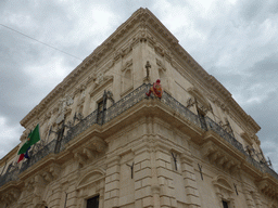 Wax statue of Spiderman hanging on the southwest corner of the Palazzo del Governo palace at the Piazza Duomo square