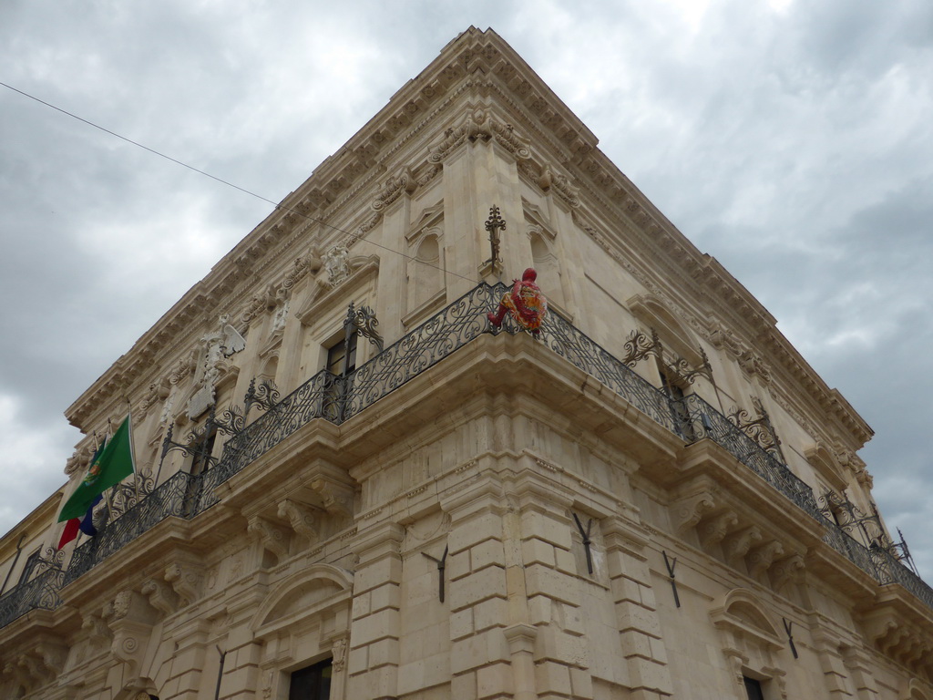 Wax statue of Spiderman hanging on the southwest corner of the Palazzo del Governo palace at the Piazza Duomo square