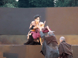 Clytemnestra and the chorus with Agamemnon`s clothes and helmet at the stage of the Greek Theatre at the Parco Archeologico della Neapolis park, during the play `Agamemnon` by Aeschylus