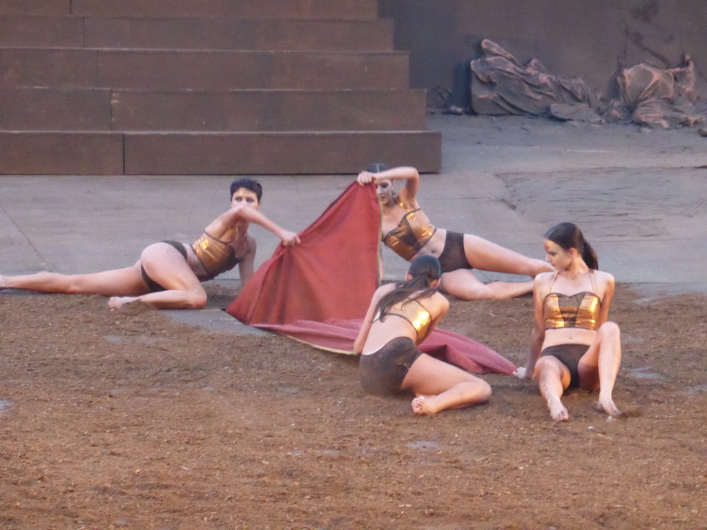Female dancers laying down the purple tapestry to the gates of Argos at the stage of the Greek Theatre at the Parco Archeologico della Neapolis park, during the play `Agamemnon` by Aeschylus