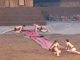 Female dancers laying down the purple tapestry to the gates of Argos at the stage of the Greek Theatre at the Parco Archeologico della Neapolis park, during the play `Agamemnon` by Aeschylus