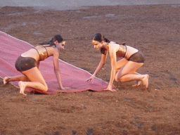 Female dancers laying down the purple tapestry to the gates of Argos at the stage of the Greek Theatre at the Parco Archeologico della Neapolis park, during the play `Agamemnon` by Aeschylus