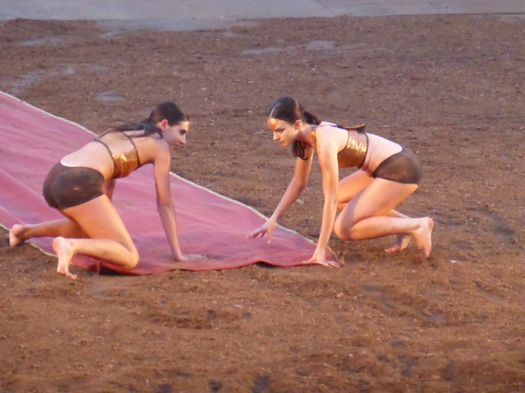 Female dancers laying down the purple tapestry to the gates of Argos at the stage of the Greek Theatre at the Parco Archeologico della Neapolis park, during the play `Agamemnon` by Aeschylus