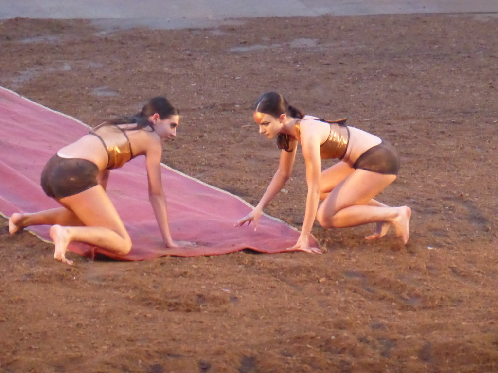 Female dancers laying down the purple tapestry to the gates of Argos at the stage of the Greek Theatre at the Parco Archeologico della Neapolis park, during the play `Agamemnon` by Aeschylus
