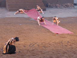 Clytemnestra and female dancers laying down the purple tapestry to the gates of Argos at the stage of the Greek Theatre at the Parco Archeologico della Neapolis park, during the play `Agamemnon` by Aeschylus