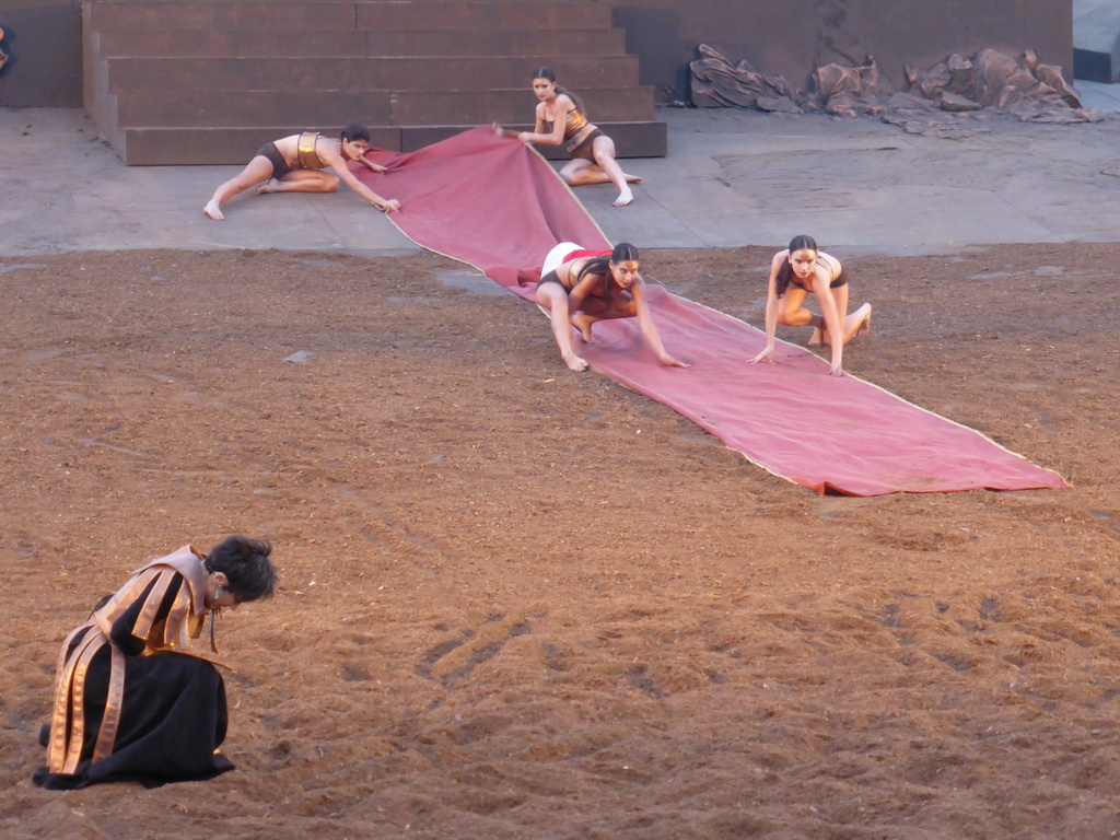 Clytemnestra and female dancers laying down the purple tapestry to the gates of Argos at the stage of the Greek Theatre at the Parco Archeologico della Neapolis park, during the play `Agamemnon` by Aeschylus