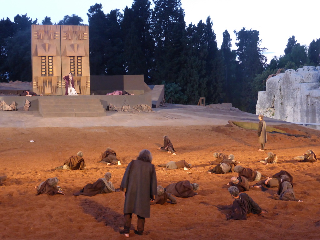 Chorus, Clytemnestra and the corpses of Agamemnon and Cassandra at the gates of Argos at the stage of the Greek Theatre at the Parco Archeologico della Neapolis park, during the play `Agamemnon` by Aeschylus