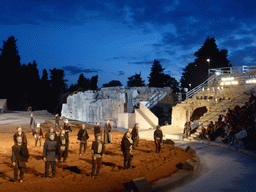 Chorus at the right side of the stage of the Greek Theatre at the Parco Archeologico della Neapolis park, during the play `Agamemnon` by Aeschylus